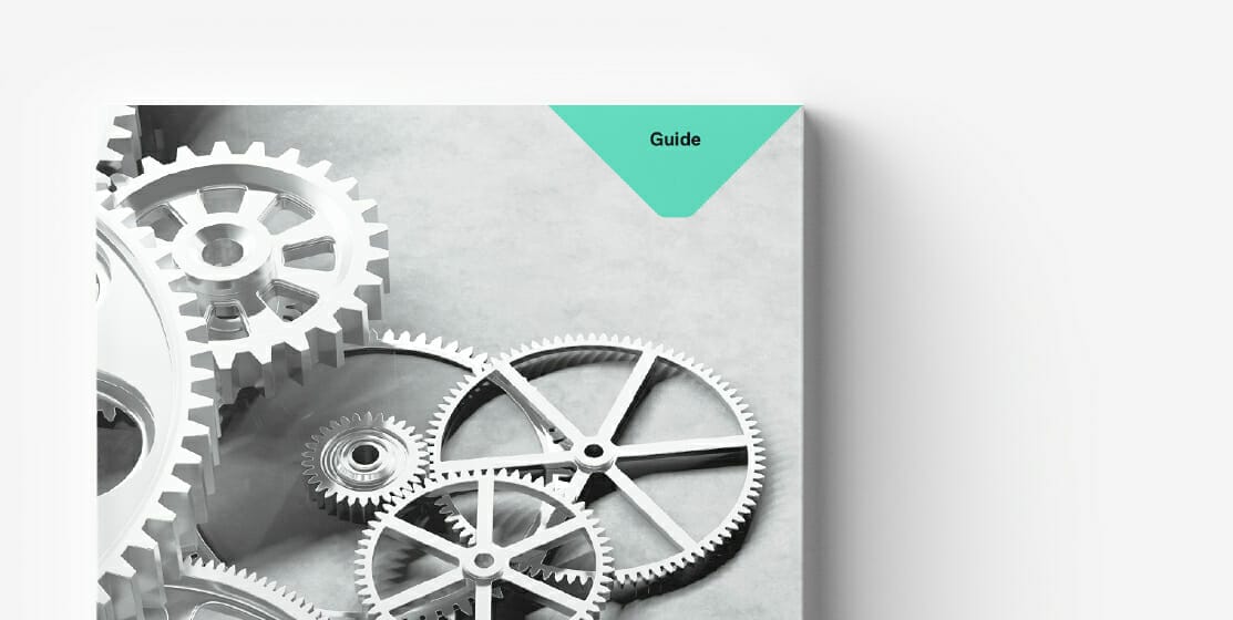 Close-up of interlocking gears in shades of gray with a green triangular label at the top right corner labeled "Guide." Perfect for navigating MVP strategies in rapidly changing markets.