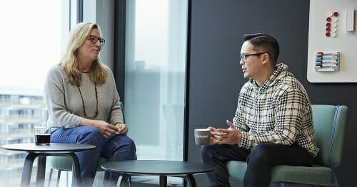 two colleagues chatting in the office