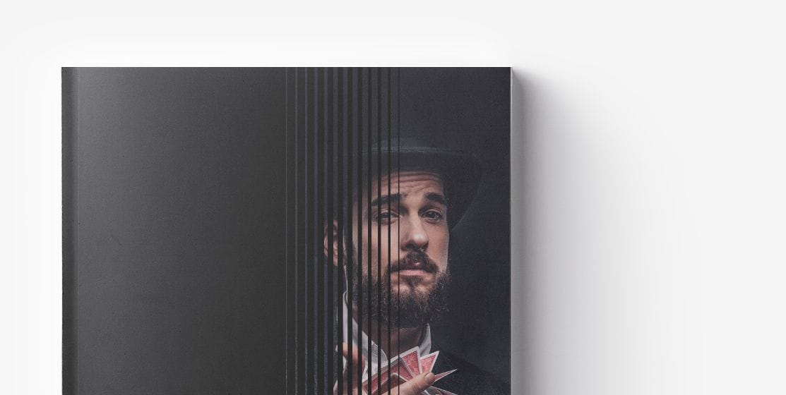 Front cover of a book with a partial image of a man wearing a hat and holding playing cards, obscured by vertical black lines on the left side, revealing secrets to Increase Bottom Line through innovative Retail E-commerce Strategies.