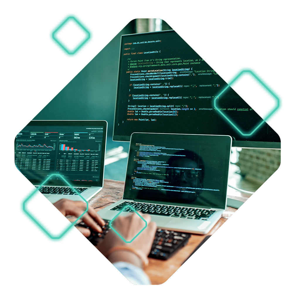 Two laptops on a desk display lines of code, and a person is typing on one of them. Another monitor in the background also shows code from an Oracle Commerce project. Geometric patterns frame the image.