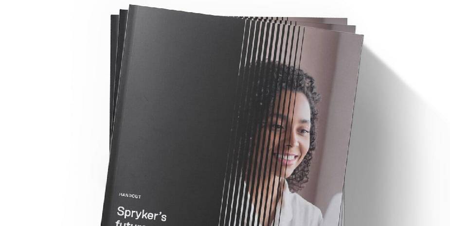 Stack of brochures titled "Spryker's Future" with a cover photo of a smiling person, highlighting the innovations in cloud-based commerce.