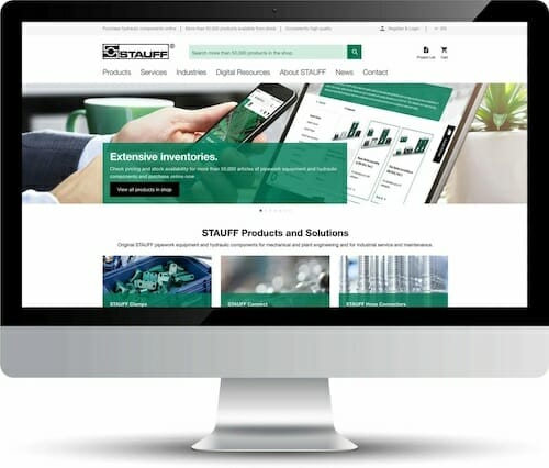 A desktop computer screen displaying the homepage of the STAUFF website, showcasing extensive inventories of fluid power products and advice on equipment, support, and industrial solutions for spryker customers.