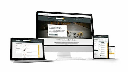 A computer monitor, laptop, tablet, and smartphone all display the same website featuring automotive parts for Spryker customers.