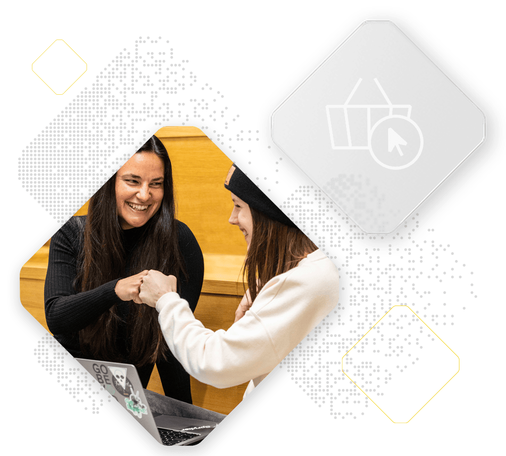 Two people smiling and fist bumping, one seated with a laptop and the other standing. Overlaid digital elements feature shopping icons, exemplifying the seamless integration of unified commerce.