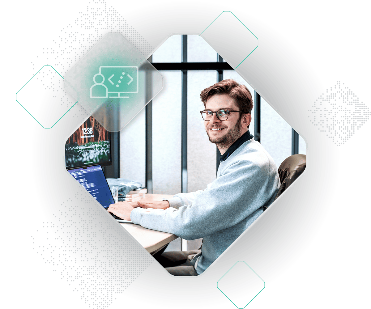 A person wearing glasses and a light gray sweater is working on a laptop at a desk. A graphic icon of two connected figures and code, symbolizing IT benefits, is overlaid on the image.