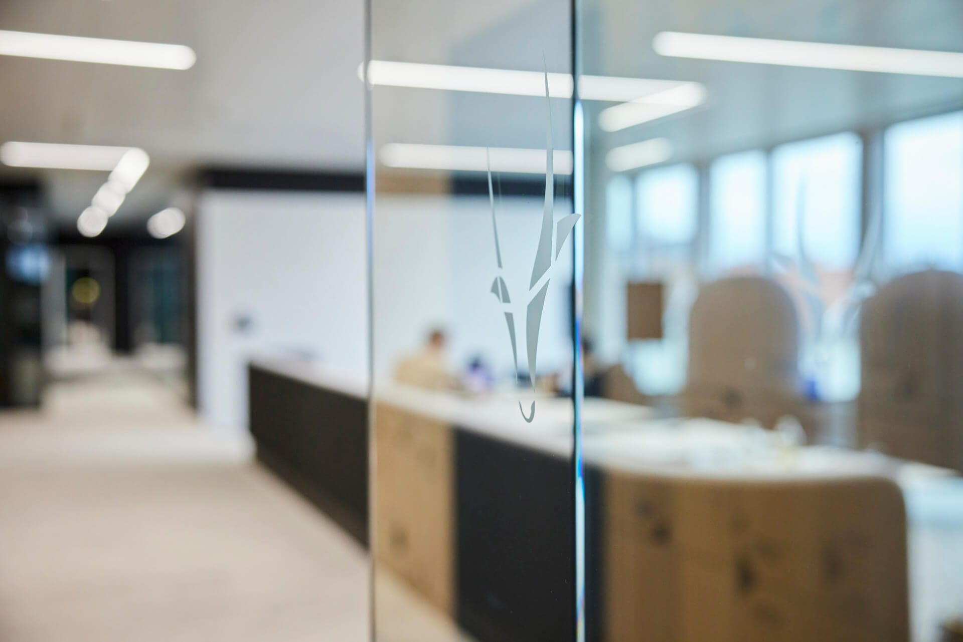 Modern office interior with a Gartner Magic Quadrant-inspired glass partition featuring a geometric design.