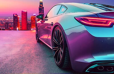 A sleek sports car, embodying the agility of a spryker, is parked on a rooftop at sunset, against a vibrant city skyline.