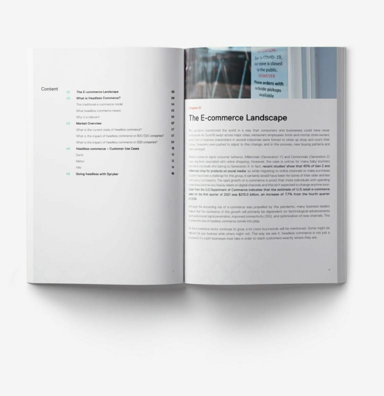 An open book displays a table of contents on the left page and a chapter titled "The E-commerce Landscape" on the right page. The surrounding text discusses the impact of COVID-19 on digital commerce, including strategies like paid search for navigating this new terrain.