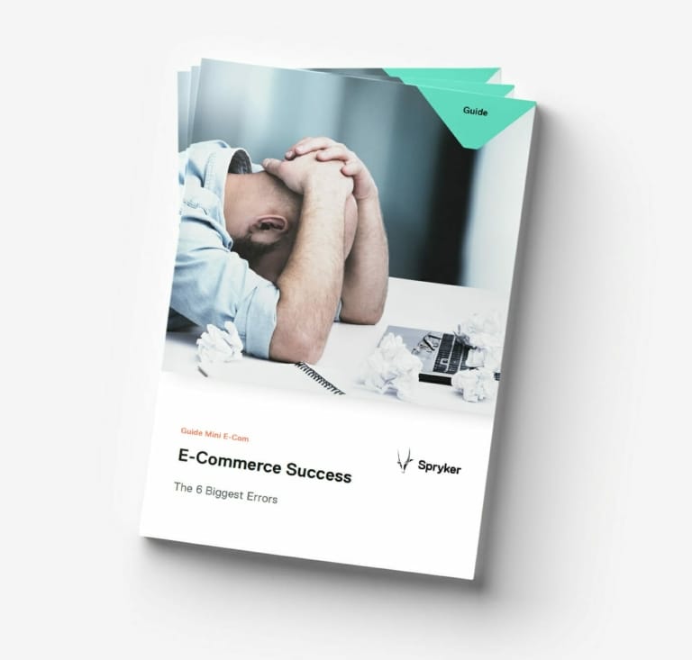 A man sits at a desk with his head in his hands, surrounded by crumpled papers. The title on the cover reads "E-Commerce Success: The 6 Biggest Errors in Rapidly Changing Markets." The guide is from Spryker.